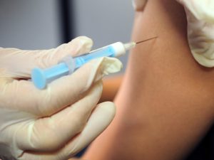 A pupil receives a vaccine against the A